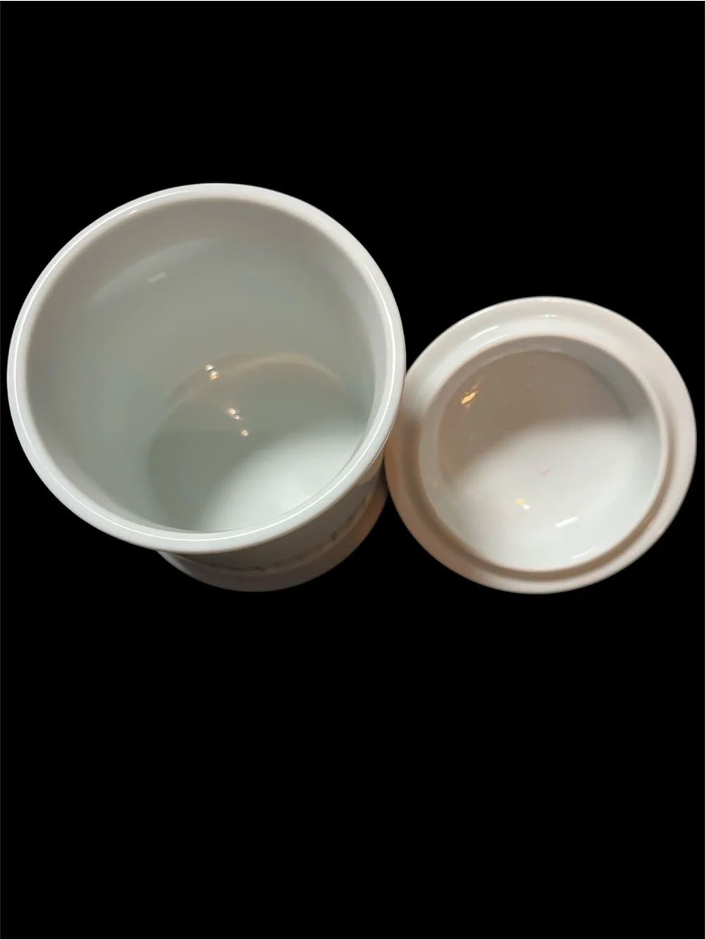 This is a vintage 1987 Avon white porcelain apothecary jar
